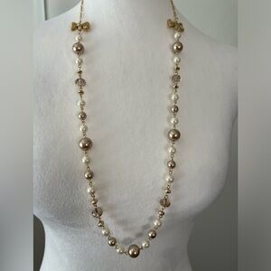 Faux pearl gold tone necklace with bows